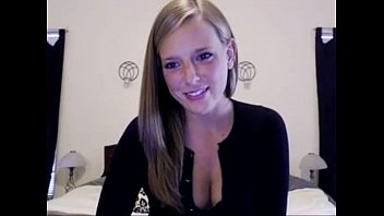 white american girl smiles and shows cleavage at home