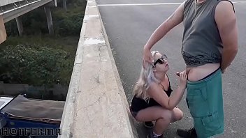 Blonde babe sucks friend on the highway bridge