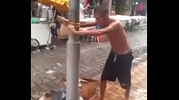 man on trying to kill a pole.