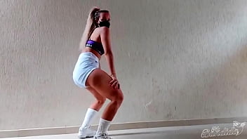 Blonde girl dancing in glued shorts