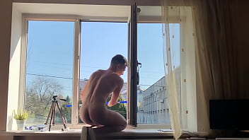 Young Full Naked Window Cleaner Washes Windows in the Morning