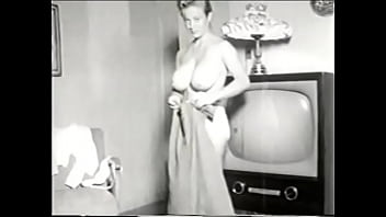 Vintage busty beauty bends over bends over TV showing her big tight breasts for you