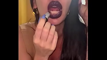 Putting lipstick on her full lips to suck a hot cock!