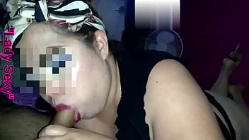 She painted her lips red, put a scarf in her hair and put on pretty makeup, in a transparent black thong and high sneakers she starts sucking cock