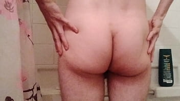 Gay twink rubs lotion all over his ass
