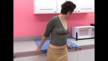 Sexy curvy brunette uses a purple dildo in the kitchen