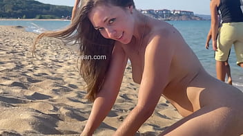 PUBLIC BEACH - Everyone watches how she spread her legs in public. Flashing with her pussy outside.