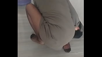 Mature woman in turbanli nylon stockings wipes floors