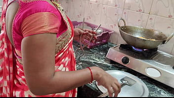 Desi Bhabhi was working in the kitchen when the servant fucked her