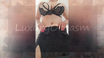 Busty beauty in black skirt and sexy bra dances in front of the camera - LuxuryOrgasm