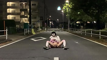 Crossdresser Mayu is enjoying exposure play with her M-shaped legs spread wide open in the middle of a driveway in a residential area late at night in a miniskirt and no panties.