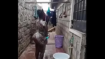 Naked Ebony taking shower outside