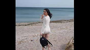 若い女性がビーチでオーガズムコントロールのためにバイブで遊んでいるところを捕まった